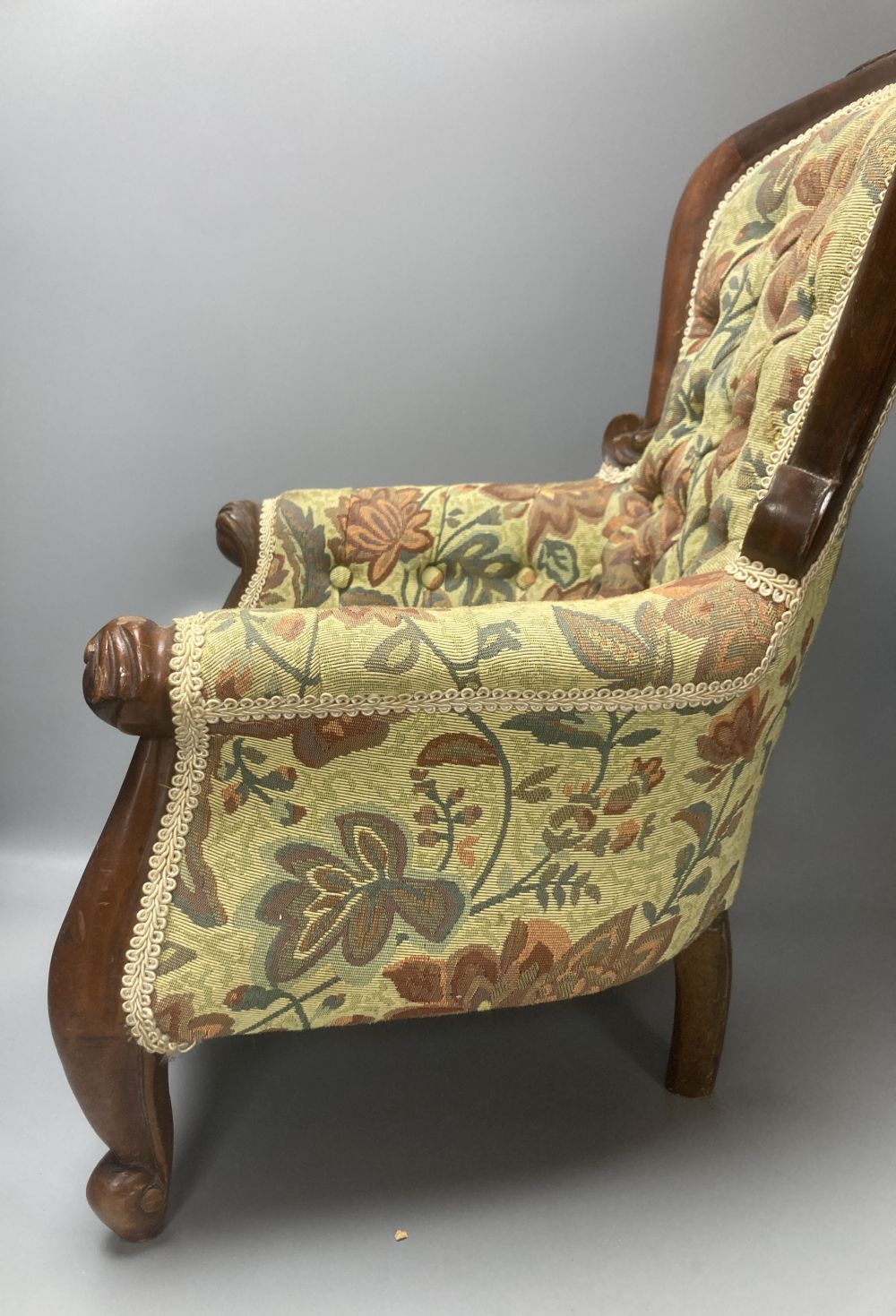 A reproduction miniature spoonback armchair